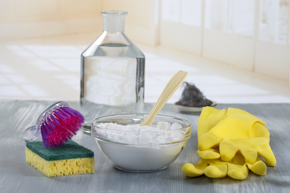 Baking soda in a bowl with cleaning products