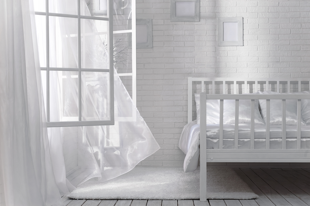 White bedroom with windows open